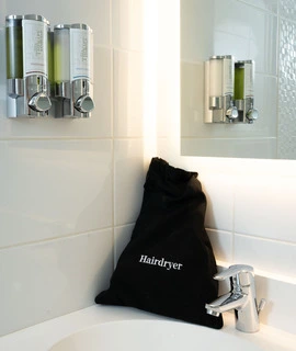 hairdryer installed in the bathroom of OSKO Hotel Toulouse Airport rooms